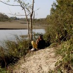 human - waiting for animals to capture behing weed camouflage